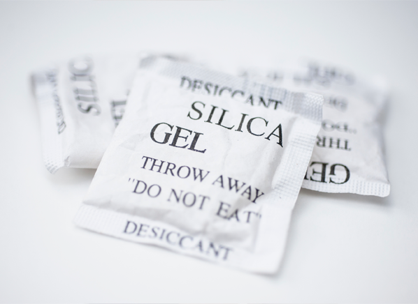 What is silica gel and why do I find little packets of it in